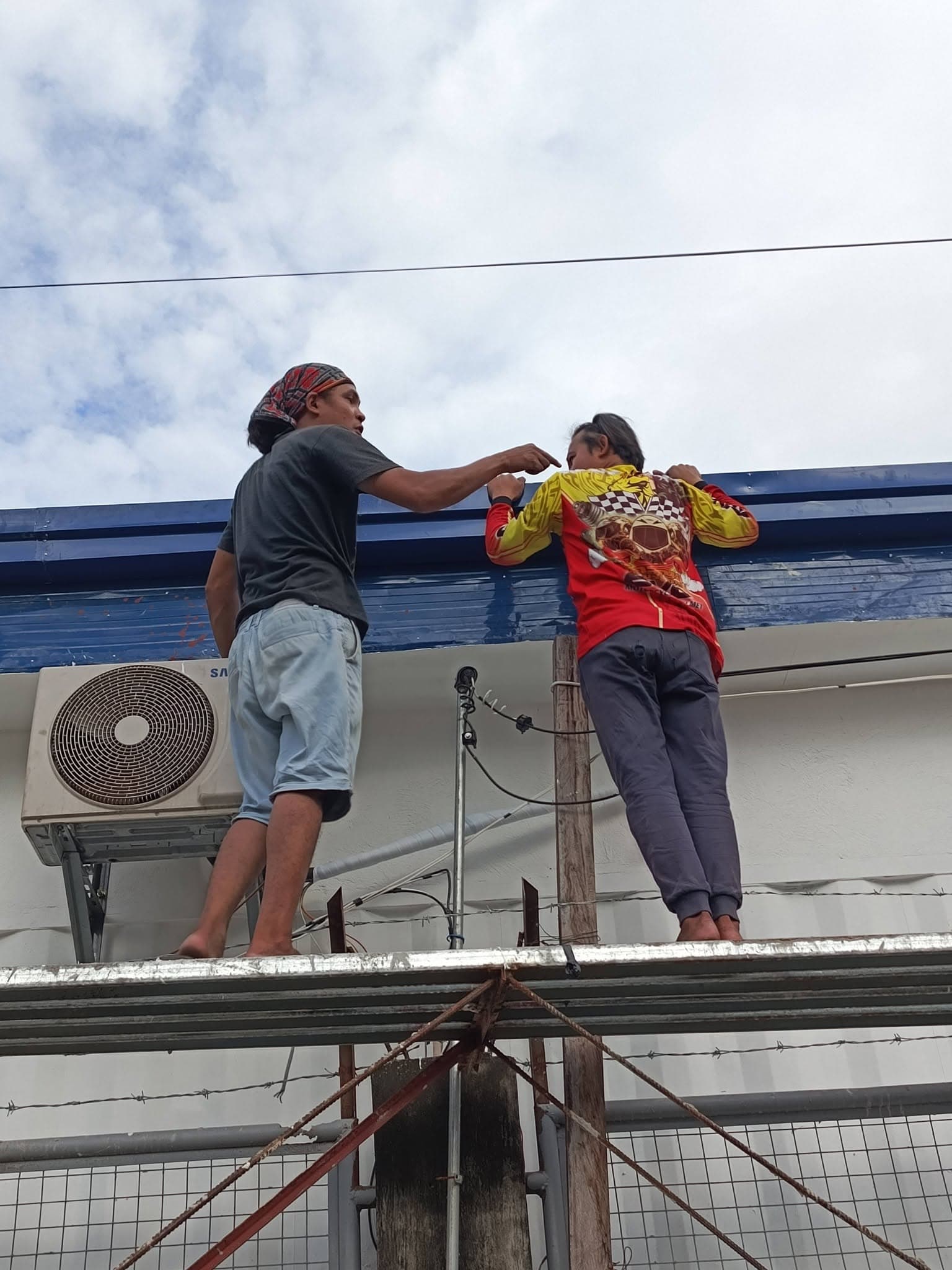 CALA technicians coordinating an outdoor split-system air-conditioning installation.